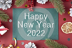 Happy New Year 2022 Sign In Lightbox And Gold Celebration Toys, Candles And Champagne On Bokeh Background.