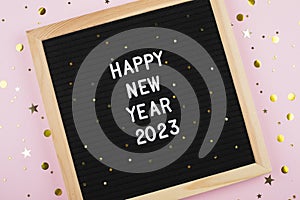 Happy New Year 2023. Congratulation for holidays on black board. Flat lay, top view