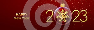 Happy New Year 2023. Golden metal 3D numbers 2023 with gold shining 3D snowflake in a Christmas glass bauble. Greeting card.