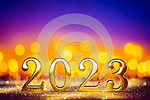 Happy New Year 2023 - golden numbers on glowing glitter