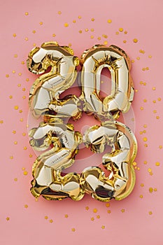 Happy New Year 2023 greeting card. 2023 golden foil balloons numbers and confetti. Top horizontal view copy space new year and