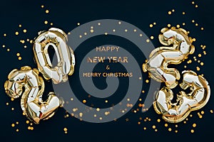 Happy New Year 2023 greeting card. 2023 golden foil balloons numbers and confetti. Top horizontal view copy space new year and