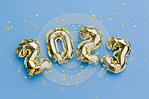 Happy New Year 2023 greeting card. 2023 golden foil balloons numbers and confetti. Top horizontal view copy space new year and