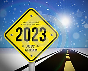 Happy new year 2023 greetings with road sign on the background of the road going into the distance planning concept and goals