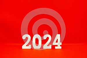 Happy New year 2024 , 2024 number wood object on red background and copy space