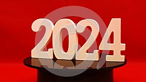 Happy New year 2024 with End of Year 2023 transition to 2024 number wood object on red background