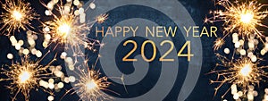 HAPPY NEW YEAR 2024 / New Year`s Eve Party background greeting card  - Sparklers and bokeh lights, on dark blue night sky