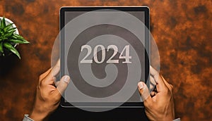 Happy new year 2024 ON TABLET HAND PEOPLE