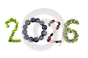 Happy New Year 2026 number made of fruits and vegetable on white