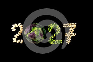 Happy New Year 2027- number made of beans, peas, grains on black wooden background