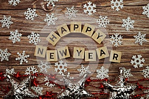 Happy New Year alphabet letter with Christmas accessories on wooden background