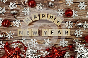 Happy New Year alphabet letter with christmas accessories on wooden background