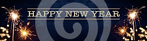 HAPPY NEW YEAR background banner panorama long greeting card - Firework, sparkling sparklers and bokeh lights on rustic blue black