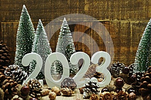 Happy New year calendar 2023 concept decoration with Christmas tree and pine cones on wooden background