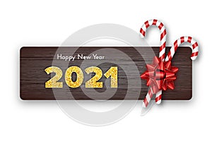 Happy New Year card 2021. Holiday candy canes and red bow on wood background. Celebration decor. Vector template