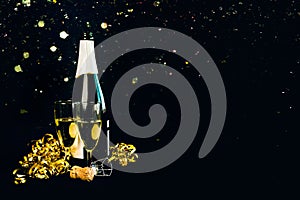 Happy New Year. Champagne bottle with two glasses,golden streamers and sparkling Glitter with space for text. New Years Eve