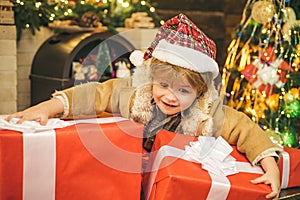 Happy new year. Child with big gift box. Christmas child holding a huge gift box. Little Santa Claus gifting gift