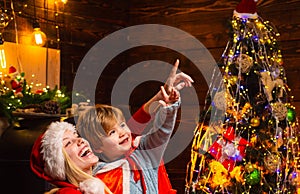 Happy new year. Childhood moments. Gifts for winter holidays at fire place. Christmas interior. Elf child. Portrait of