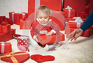 Happy new year. Christmas baby Indoor. Little girl received a gift. Present box. Little girl holding christmas gift