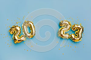 Happy New year and christmas holiday concept 2023. Gold balloons with glitter stars on blue background. Gift card with space for