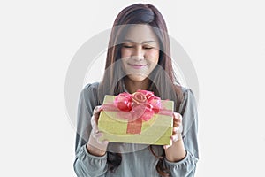 Happy New Year, Christmas and Holiday Seasonal Concept. Portrait of young asian smiling woman close eye and holding  a beautiful