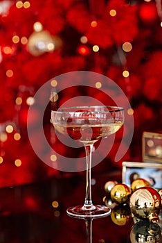Happy New Year 2021. Christmas and New Year holidays red minimal background, winter season. A glass of champagne against a