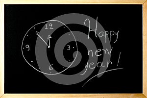 Happy new year clock on a blackboard