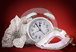 Happy New Year clock, masquerade party mask and festive white flowers