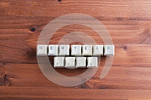 Happy new year 2018 on computer keyboard keys buttons on wooden