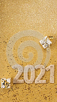 Happy new year concept. Card with handcrafted lettering 2021 and gold gift. Space for text
