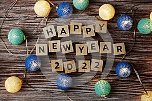 Happy New Year 2022 decorate with LED cotton ball on wooden background