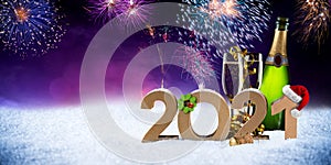Happy new year eve 2021 number colorful fireworks with santa hat four leaf clover champagne bottle glass on snow front of red