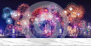 Happy new year fireworks over cityscape at night with empty white marlbe table,Banner mock up template for display or montage of