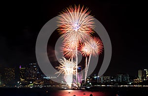 Happy new year fireworks over cityscape at night.holiday celebration festival