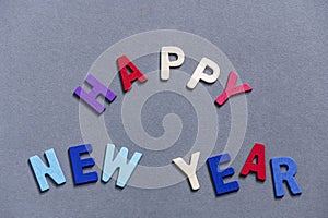 Happy new year font art colorful texting for greeting or celebrate card with gray background,