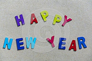 Happy new year font art colorful texting for greeting or celebrate card with light brown background,