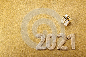 Happy new year gold card with handcrafted lettering 2021 and gift. Space for text. Top view