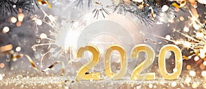 Happy New Year 2020. Golden Background with Confetti photo