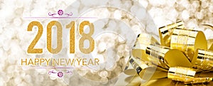 Happy new year 2018 with golden gift box with big bow at sparkling bokeh blur background,Holiday greeting card banner