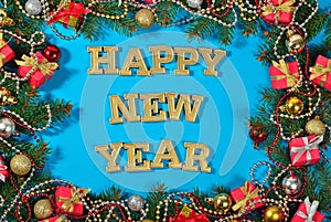 Happy New Year golden text and spruce branch and Christmas decor