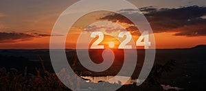 Happy New Year greeting card 2024, Silhouette number of 2024 letters on the mountain with sunset on mountains landscape in