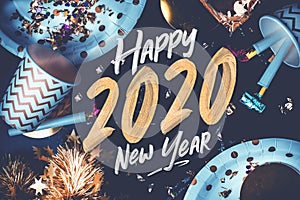 2020 happy new year hand brush storke font on marble table with party cup,party blower,tinsel,confetti.Fun Celebrate holiday party