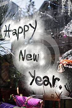Happy new year letter on glass, focus on wording photo
