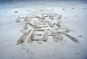 Happy New Year lettering on the beach.