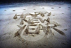 Happy New Year lettering on the beach.