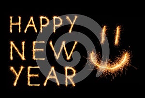 HAPPY NEW YEAR lettering and happy weird smiling smiley drawn with bengali sparkles isolated on black