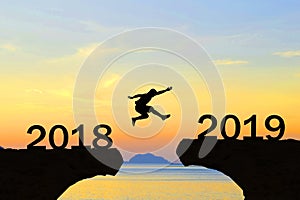 Happy New Year 2019 Men jump over silhouette