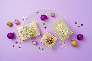Happy New Year and Merry Christmas background with golden gift boxes, ornaments and purple decoration. Top view, flat lay