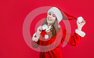 happy new year. merry christmas. cheerful teen girl celebrate xmas party. kid wear red santa claus hat. child santa