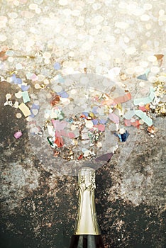 Happy New Year. New Years Eve celebration concept background.Champagne bottle with confetti